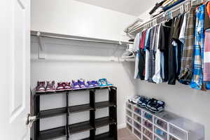 Spacious closet with carpet floors