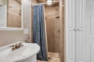 Bathroom with walk in shower and sink