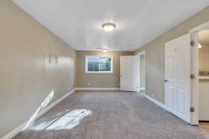 Carpeted empty room featuring a textured ceiling and washer / clothes dryer