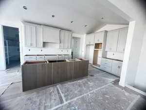 Kitchen featuring lofted ceiling and a center island