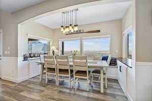 Dining space with a chandelier and wood-type flooring