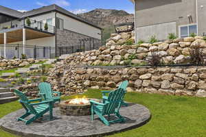 View of yard featuring a mountain view and an outdoor fire pit