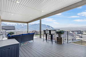 Deck with outdoor lounge area and a mountain view