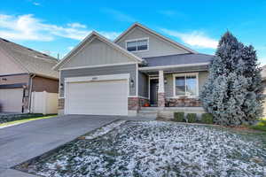 Craftsman inspired home featuring covered porch and a garage