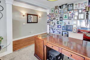 Office featuring hardwood / wood-style floors and ornate columns