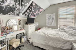 Carpeted bedroom with vaulted ceiling