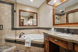 Bathroom with vanity and separate shower and tub