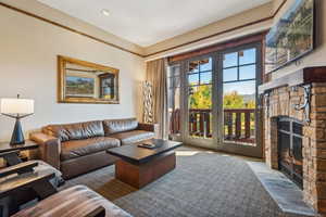 Living room featuring carpet and a fireplace