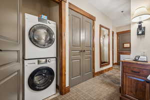 Clothes washing area featuring stacked washer / drying machine