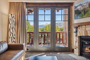 Doorway featuring a mountain view, carpet floors, and a fireplace