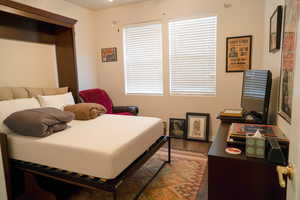 Bedroom with wood-type flooring