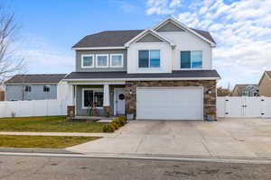 Craftsman-style house featuring a garage, a front lawn, and a porch