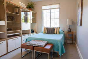 Carpeted bedroom with multiple windows