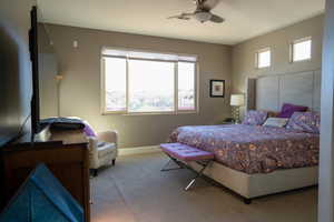 Carpeted bedroom featuring ceiling fan