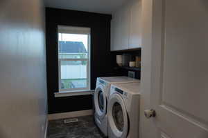 Laundry area featuring washer and dryer and cabinets