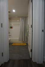 Bathroom with shower / bath combination with curtain and hardwood / wood-style floors