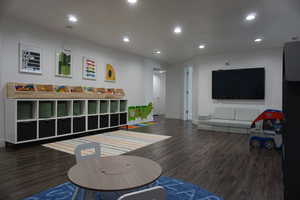 Recreation room featuring dark hardwood / wood-style flooring