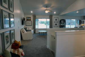 Interior space with ceiling fan and lofted ceiling