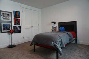 Bedroom featuring carpet flooring and a closet