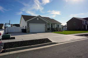 View of front of home featuring a garage and a front lawn