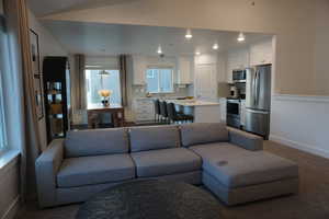 Carpeted living room featuring sink