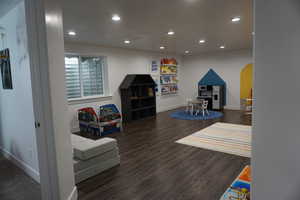 Recreation room featuring dark hardwood / wood-style flooring