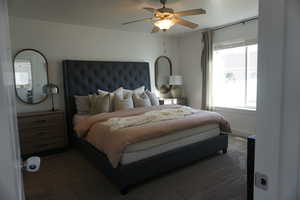 Bedroom with dark colored carpet and ceiling fan