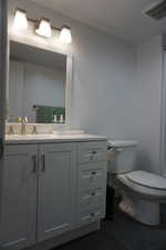 Bathroom with tile patterned flooring, vanity, and toilet