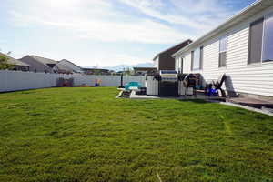 View of yard with a mountain view and a patio