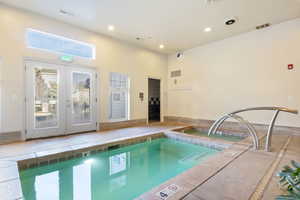 View of pool with french doors