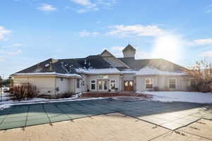 View of swimming pool with a patio area and french doors