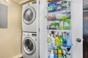 Washroom with electric panel and stacked washing maching and dryer