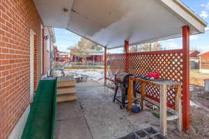 View of patio featuring a grill