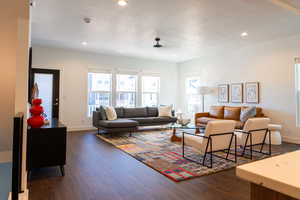 Living room with dark hardwood / wood-style floors and a textured ceiling