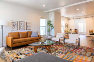 Living room featuring a barn door and hardwood / wood-style flooring