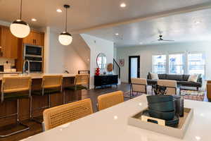 Dining area featuring ceiling fan and a textured ceiling