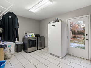 Clothes washing area featuring washing machine and clothes dryer