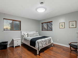 Bedroom with dark wood-type flooring