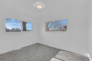 Carpeted empty room with plenty of natural light