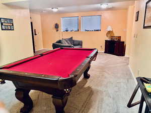 Game room with light colored carpet and pool table