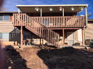 Back of property featuring a wooden deck