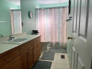 Bathroom featuring vanity, toilet, and walk in shower