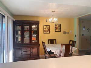 Dining space featuring carpet flooring and an inviting chandelier