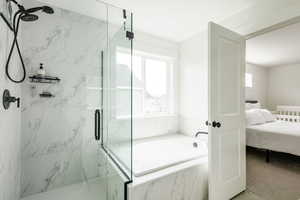 En suite Bathroom featuring shower with separate bathtub