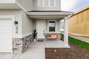 Entrance to property featuring a porch and a garage