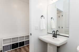 Bathroom featuring hardwood / wood-style flooring and sink