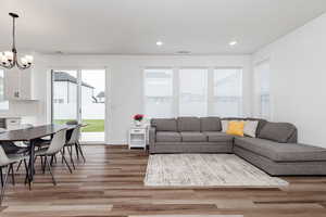 Living room featuring hardwood / wood-style floors and and chandelier over dining table.