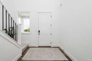 Foyer entrance featuring medium wood-type flooring