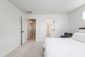 Bedroom featuring light colored carpet