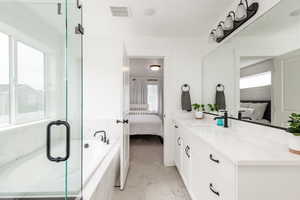 En Suite Bathroom with vanity and a relaxing tiled tub